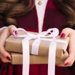 woman holding presents wrapped gifts