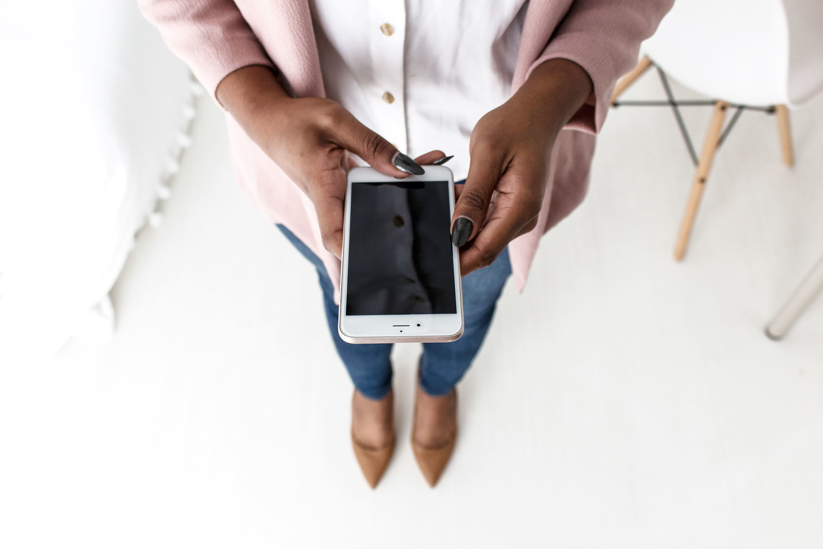 African-American woman holding iPhone