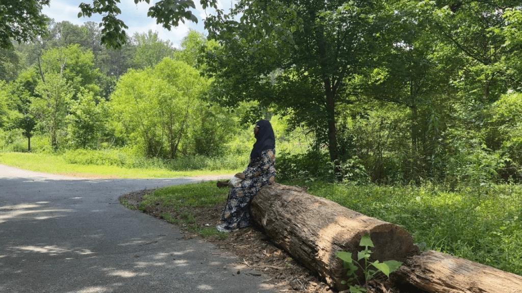 Jessica Dukharan sitting on a tree at a park